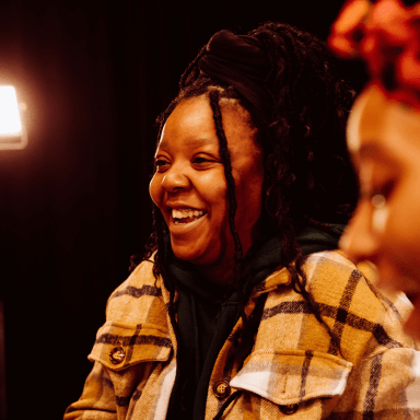 A photograph of Urielle Klein-Mekongo. She has long braided hair tied up on top of her head.